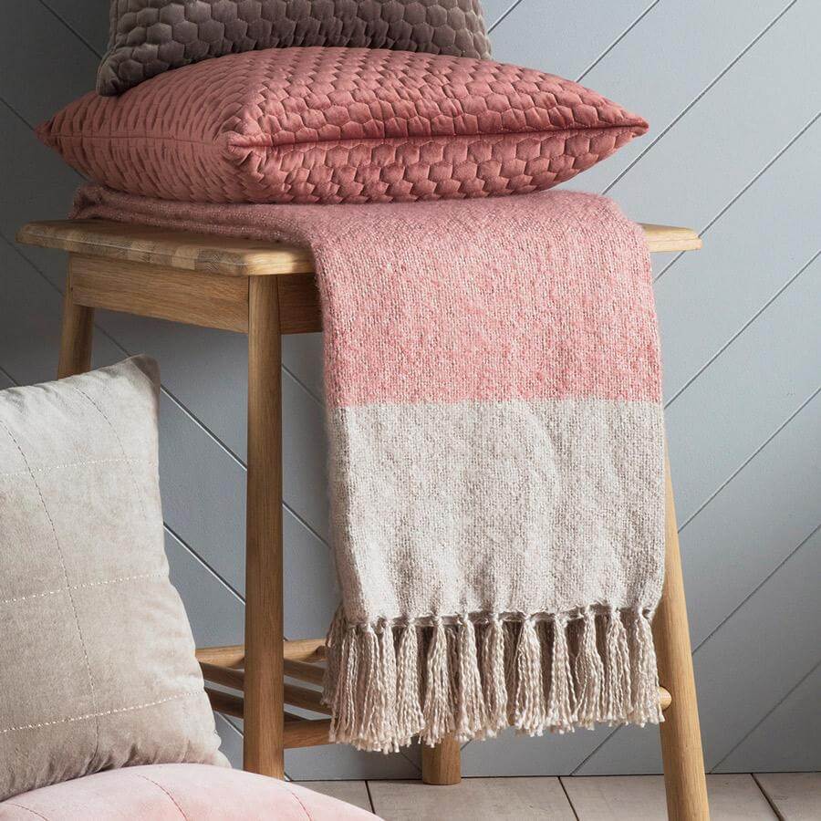 Fringed blush and silver throw