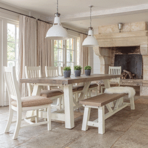 modern farmhouse extending dinging table 2m. surrounded by 1 bench and 5 matching chairs in front of window and large stone fireplace