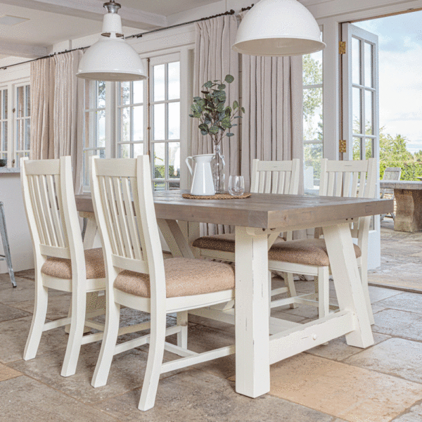 modern farmhouse extending dining table in front of open patio door with 4 x matching chairs