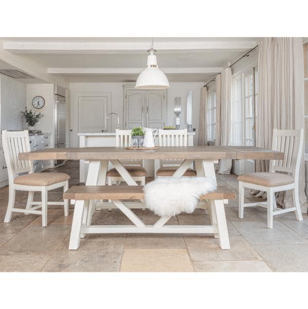 modern farmhouse dining table with both sides extended. surrounded by 4 chairs on sides and back and bench in the foreground- all in a white kitchen setting