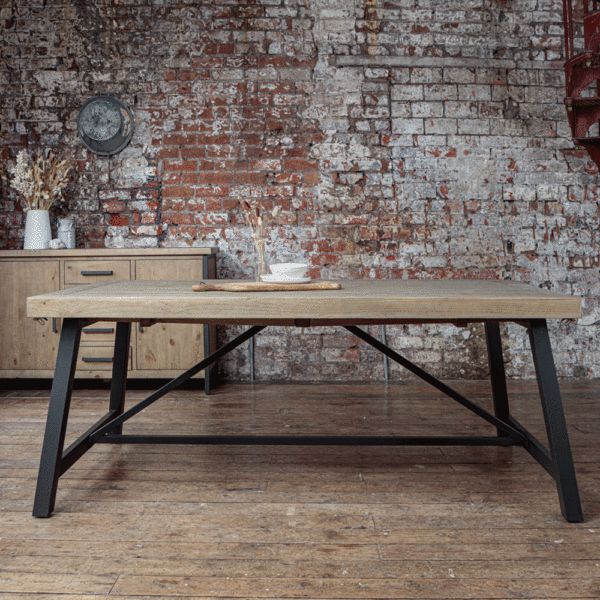 Urban extendable dining table- 2m. infront of an exposed brick wall