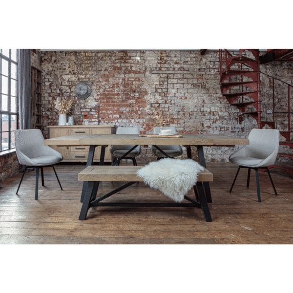 Urban 1.6m extendable table set with both ends extended. surrounded by light grey gaudi chairs and bench with fluffy white throw