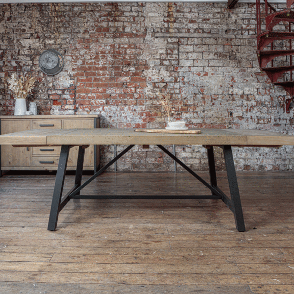Urban 1.6m extendable dining table with both ends extended infront of exposed brick wall