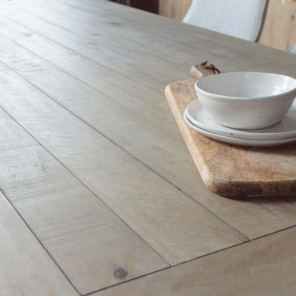 Close up of Urban extentable table top with white bowl and plates stacked on wooden block