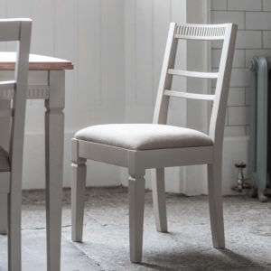 The Atlantic dining chair in neutral grey placed next to Atlantic dining table