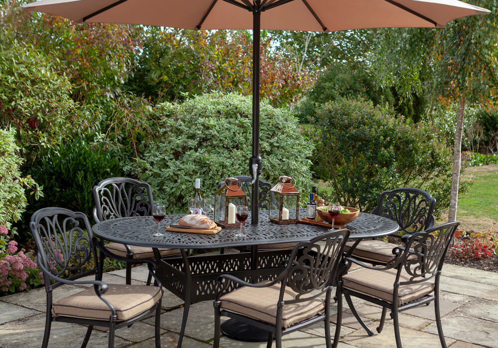 Hartman Amalfi 6-Seat garden dining table with open parasol on a garden patio