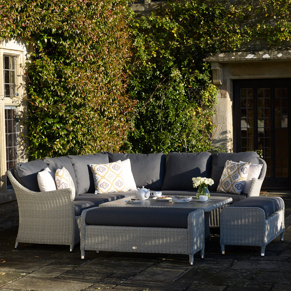 Bramblecrest Monterey 8 Seater Outdoor Sofa Set in an ivy-covered courtyard