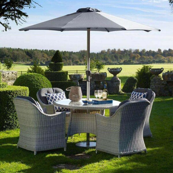 2019 Bramblecrest Monterey 4 Seat Garden Dining Set With Round Table placed on a garden lawn