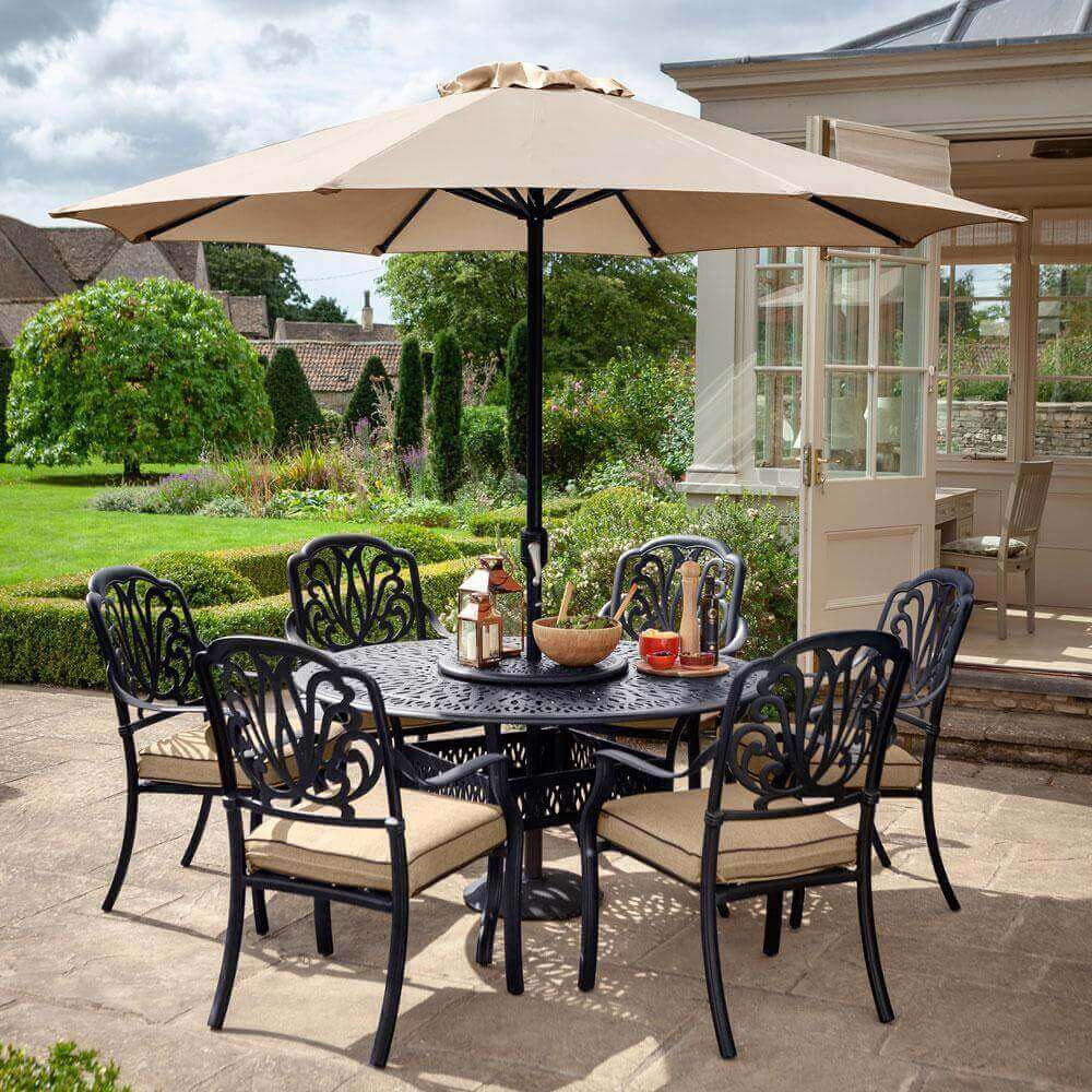 2021 Hartman Amalfi 6 Seat Round Dining Table Set in Bronze/Amber on a garden patio outside a conservatory