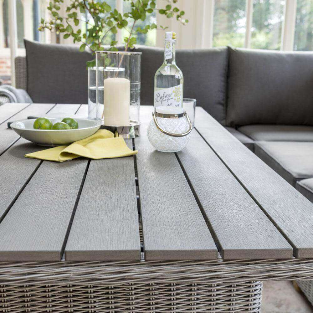 close up of slat table from Kettler Palma corner set with ornaments, vase and fruit bowl placed on top