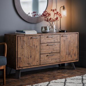 The Loft Sideboard with a vase, books and lamps assembled on top