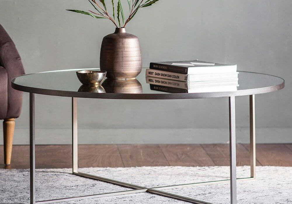Brennan Coffee Table in silver with books, vase and ornaments on top