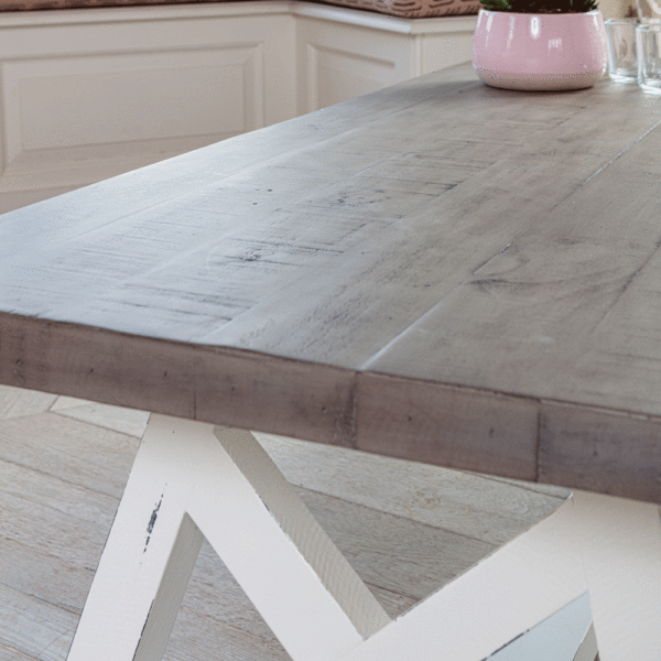 close up of white and grey coffee table surface with pink plant pot to the right in background