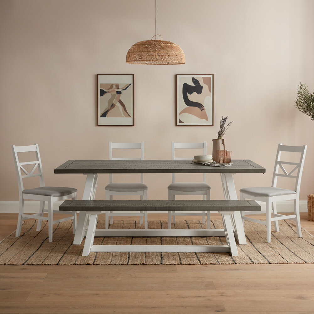large white and grey extendable dining table with large matching wood bench and four white dining chairs