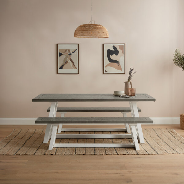 white and grey extendable dining table flanked with large matching dining benches