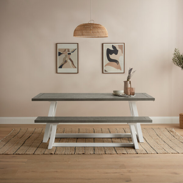 white and grey extendable dining table with large dining bench sat on brown carpet in neutral colour dusky room