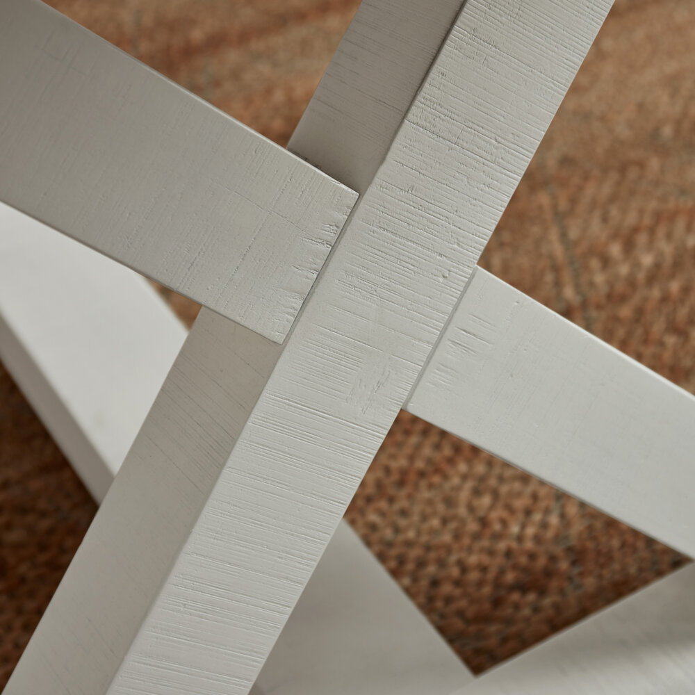closeup cross base segment of white base from white and grey extendable dining table