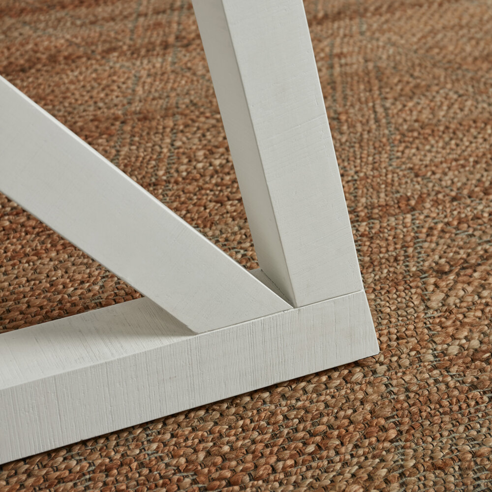 closeup corner segment of white base from white and grey extendable dining table
