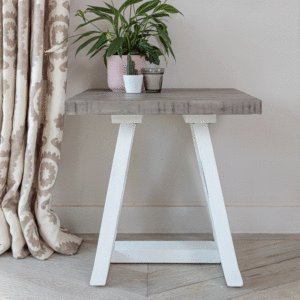 full photo of white and grey lamp table with plants and candle on top