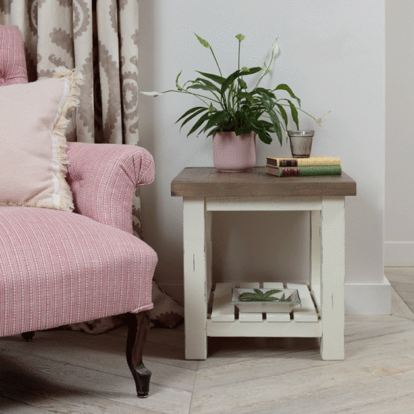 modern farmhouse side table with objects on top next to pink armchair