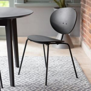 Dalby Dining Chair in black placed on a patterned rug
