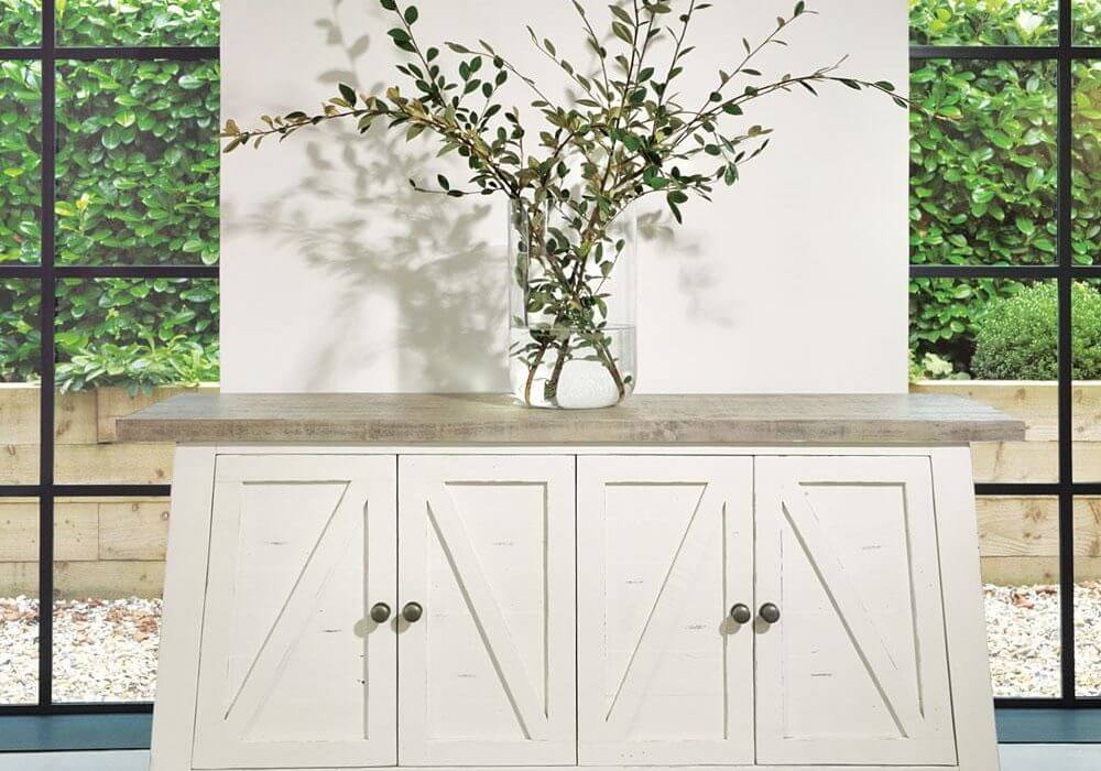 Example of Farmhouse-style furniture. White and Grey Sideboard in an indoor setting