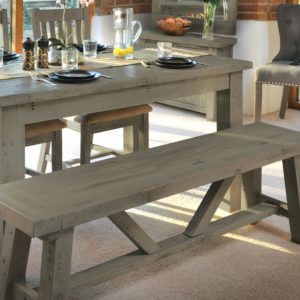close up of Cotswold dining bench as part of dining table set with the table laid for dinner