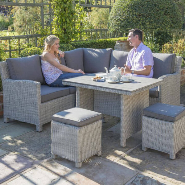 Couple shown sitting on Kettler palma mini dining corner sofa set with slat table