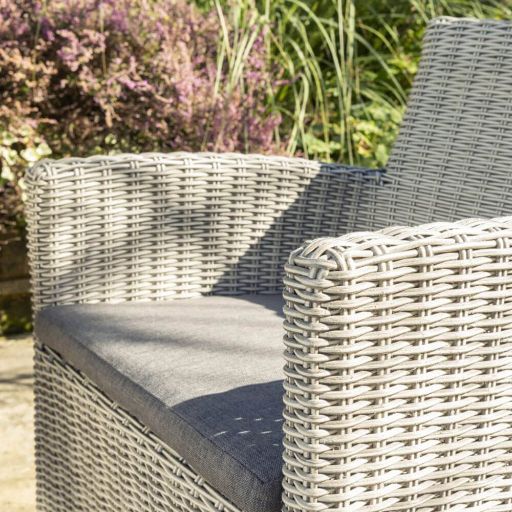Close up of Palma dining chair- whitewash. Pictured outdoors in the sunshine