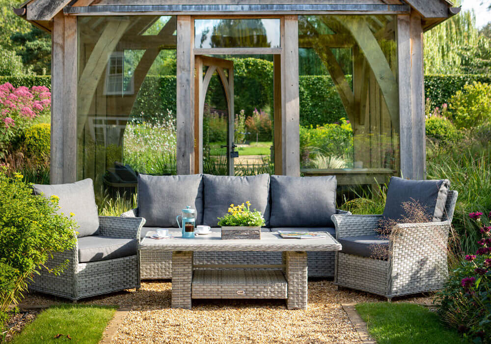 Long shot of Hartman heritage garden lounge set- ash/ slate outside infront of timber sun house