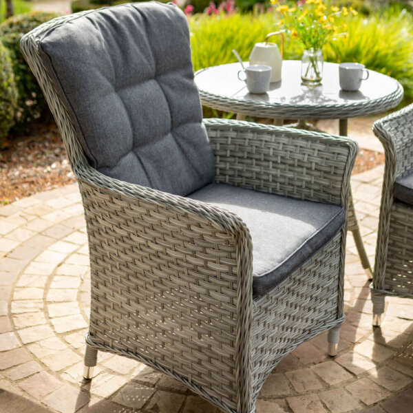 heritage bistro set focus on one chair on round stone patio with matching table in background