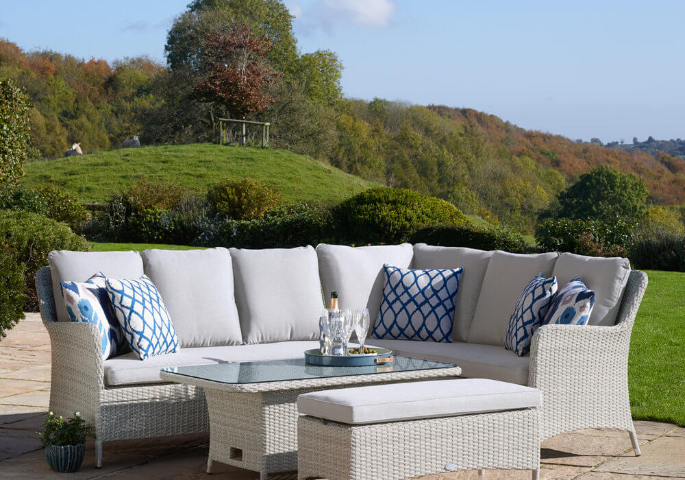 Bramblecrest Tetbury Garden Dining furniture set with adjustable table in a sunny countryside setting