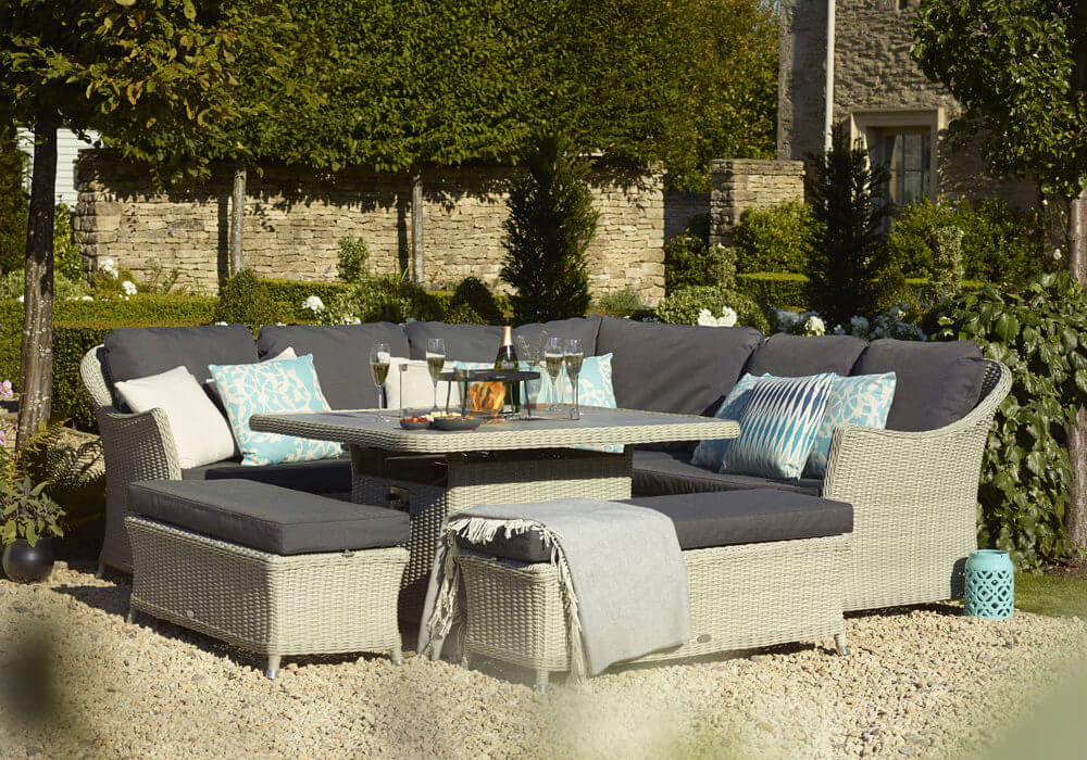 Bramblecrest Monterey garden sofa set in a walled garden next to house