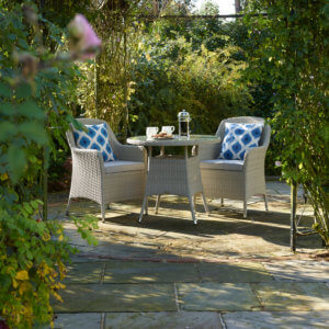 twin_chairs_and_table_in_shaded_leafy_courtyard