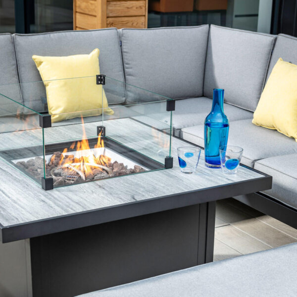 Hartman Atlas Fire pit table with sofa behind