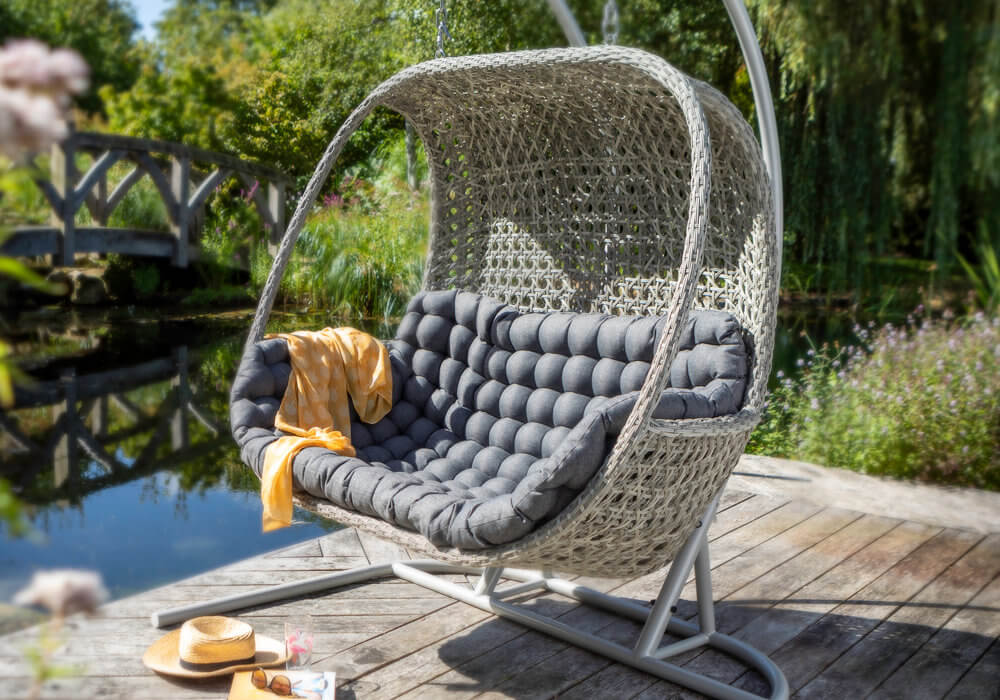 Ash and Slate 2021 Hartman Heritage Double Hanging Cocoon Chair on a wooden deck near a pond