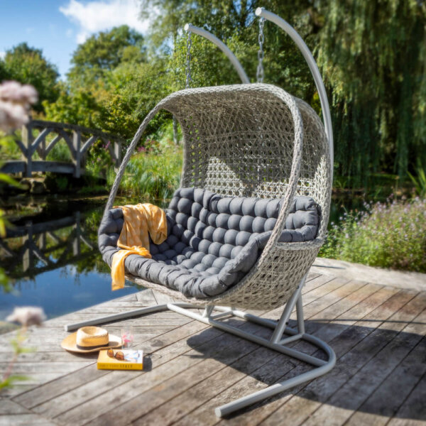 Ash and Slate 2021 Hartman Heritage Double Hanging Cocoon Chair on a wooden deck near a pond