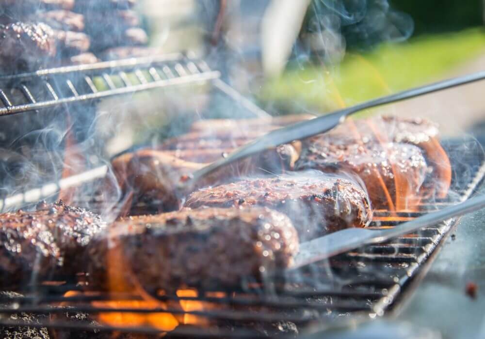 close up of smoking meat on BBQ