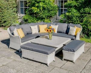 bramblecrest monterey outdoor sofa with square table and 2 x cushioned benches on patio outside house covered in ivy