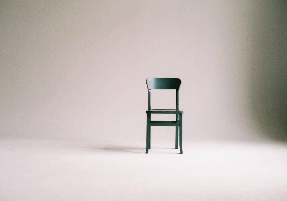 painted wooden chair against white wall