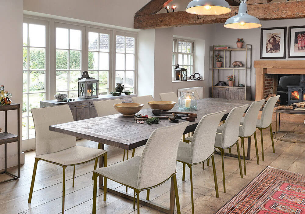 Wiltshire nutmeg dining table long shot. table extended with 10 chairs in cosy dining room setting