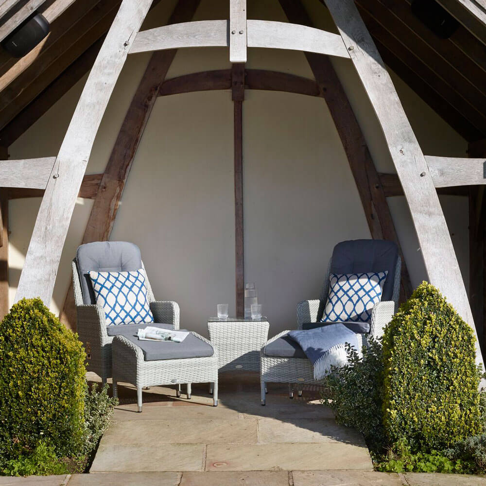 2020 Bramblecrest tetbury garden recliner set with 2 x footstools on an outdoor patio under beamed structure
