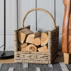 cabin log carrier basket with split wood and handle sat on grey rug with wood board wall background