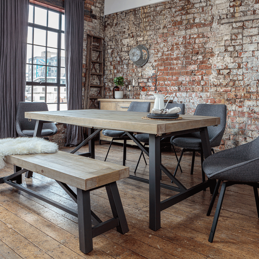 Urban dining table set with Gaudi dining chairs in an urban style room with exposed brick walls