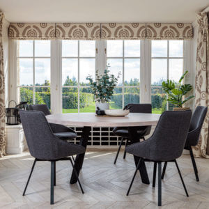 Valencia Round Natural Oak Dining set with 5 x Gaudi Dining Chair Dark Grey in bay window with garden view
