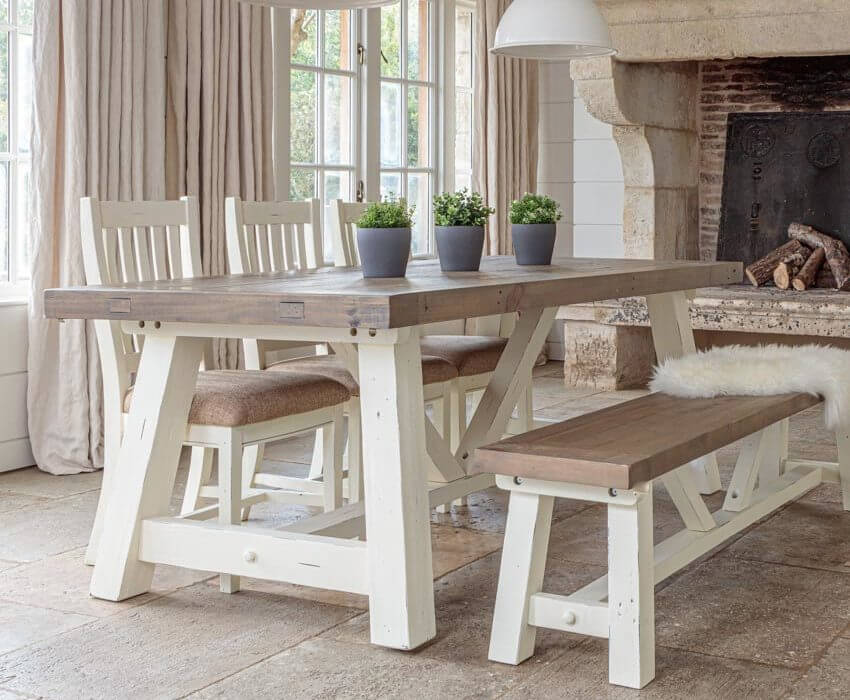 white and grey modern farmhouse extendable dining table set with matching bench and 3 chairs in front of window and stone fireplace