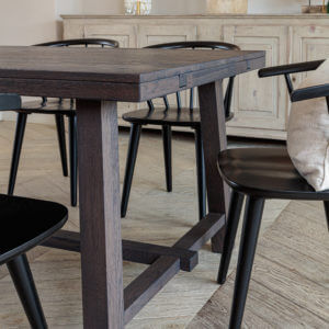 Close up of the end of Kitsilano 1.7m extendable solid oak dining table dark brown with 4 chairs around