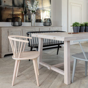 left angle view of Kitsilano 1.7m extendable solid oak dining table-whitewash with 3 plant pots on in farmhouse room
