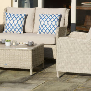 Sofa_With_@_Blue_Patterned_cushions_And_Armchair_On_Paving