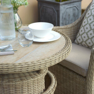 Close_Up_Details_Shot_Of_Round_Garden_dining_Table_With_Wicker_Border_And_Cup_of_Tea